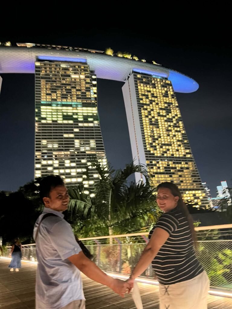 Travelers at Marina Bay Sands at night, Singapore
