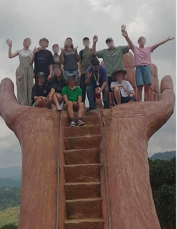 Travelers on a giant hand viewpoint
